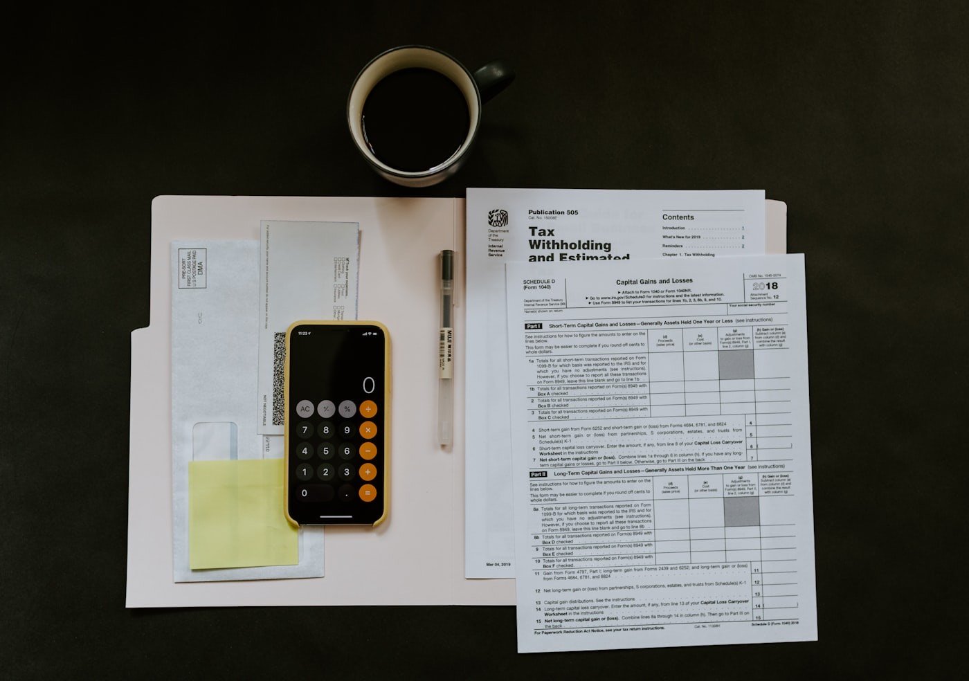 Tax return forms and a calculator — the statutory compliance backbone run by a chartered accountant