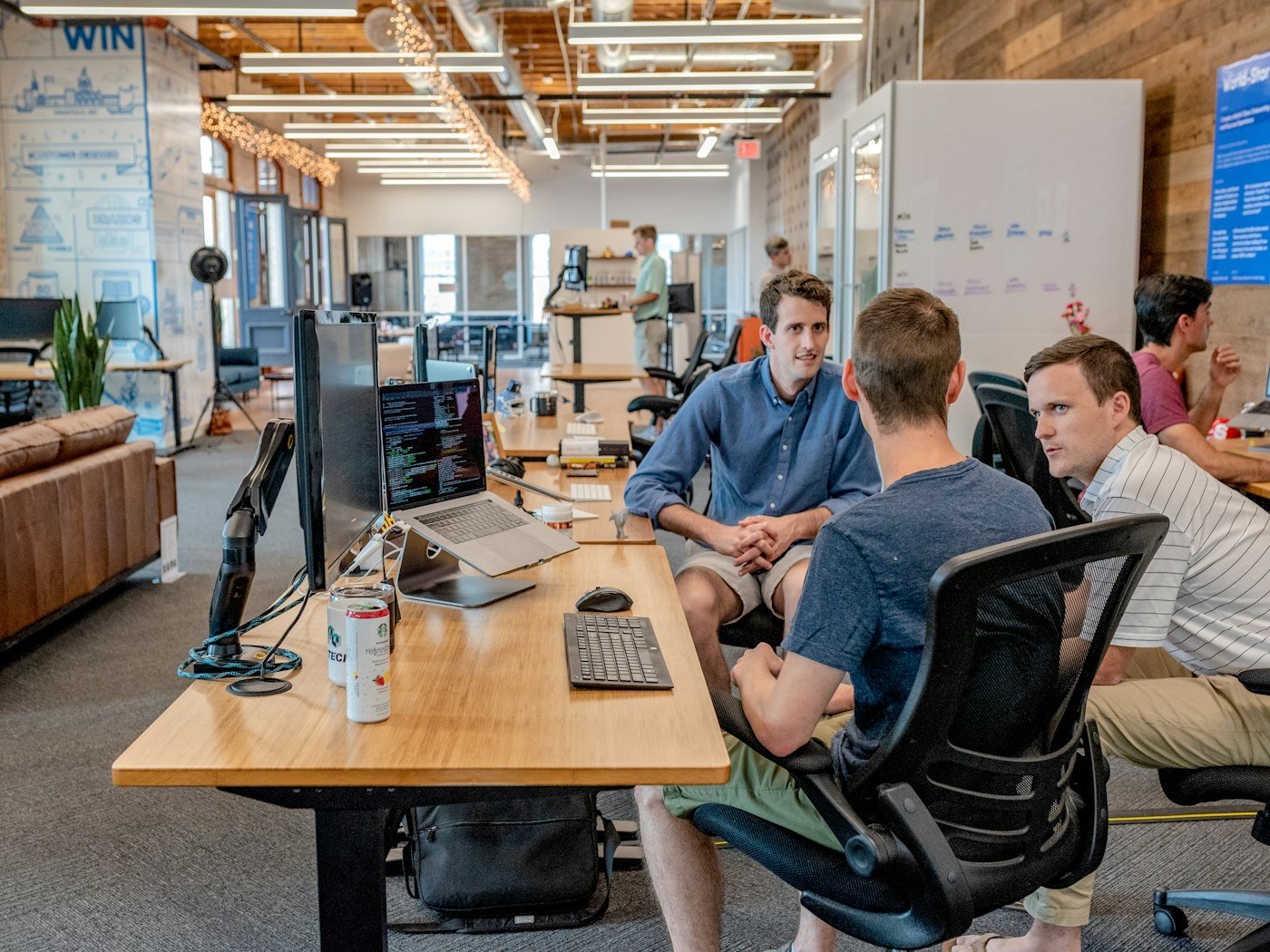 A startup team at work in an open-plan office — founders preparing to raise a priced round